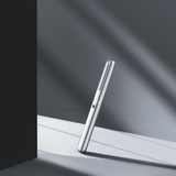 Silver fountain pen on a reflective surface with a dark background