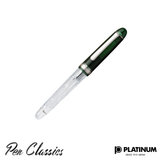 A green and clear Platinum pen with the cap on the pen facing up