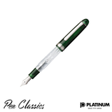 A green and clear Platinum pen with the cap posted to the pen and the nib facing down