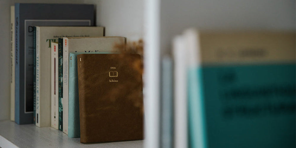 Stack of books on a shelf with a blurred foreground