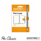 A Leuchtturm Rising Sun orange coloured pen loop attached to orange cardboard packaging